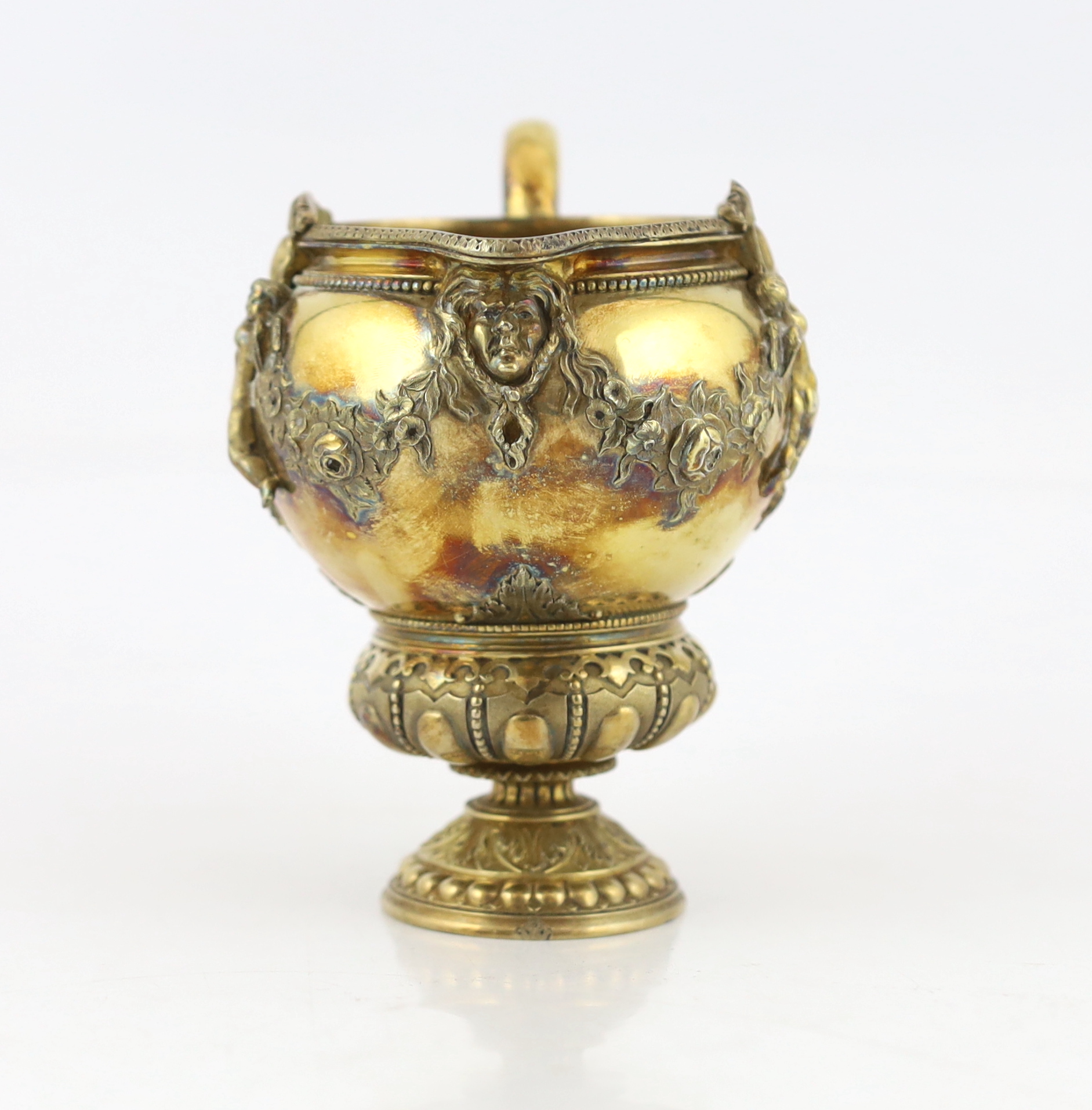 An early Victorian ornate silver gilt cream jug, by George Ivory